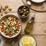 Mediterranean diet foods including chickpea salad, olive oil, lemon and whole grain bread